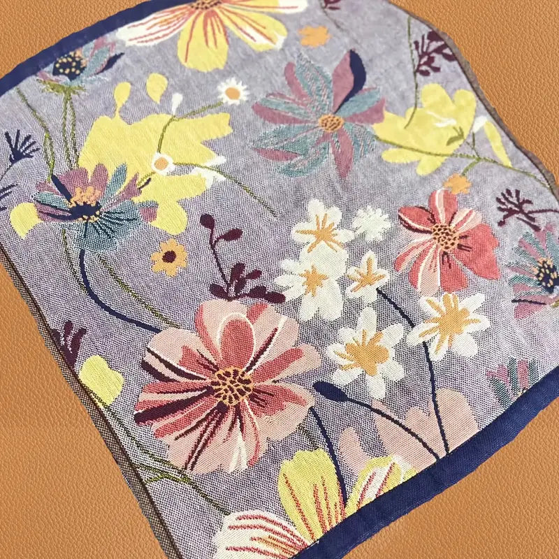 Floral patterned fabric with colorful flowers on a gray background