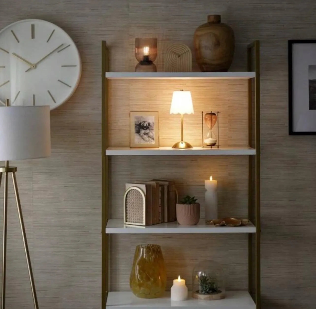 Decorative shelf with various items against a wooden wall.