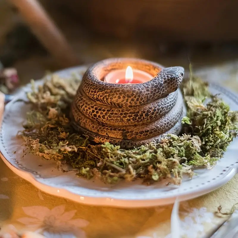 Decorative candle holder with a lit candle on a bed of moss