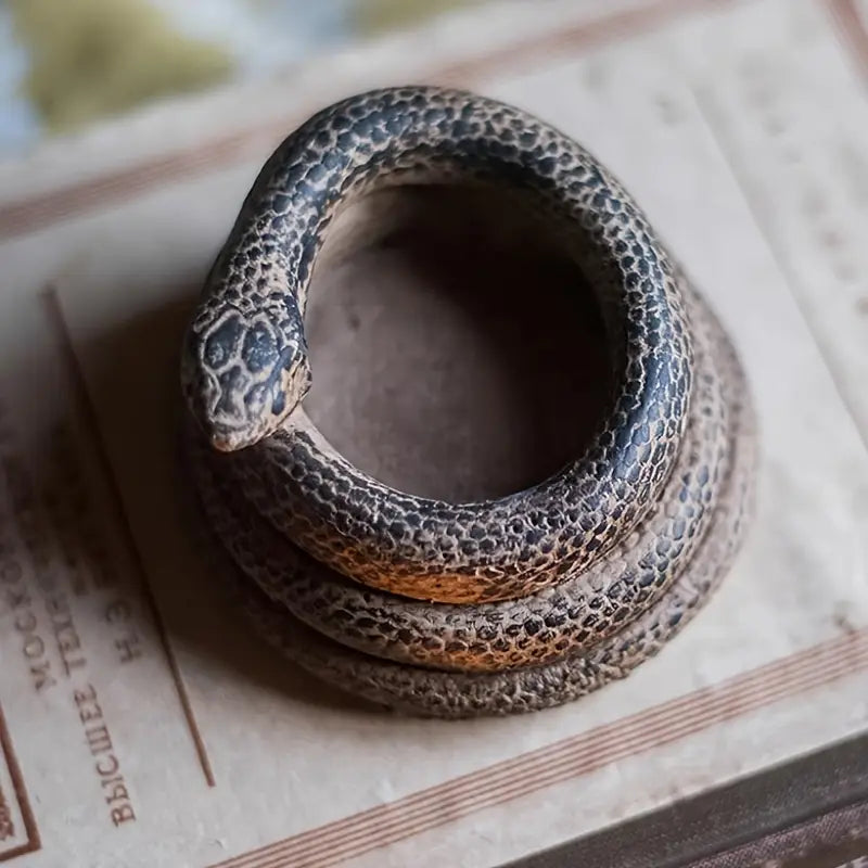 Coiled snake on a textured surface with text