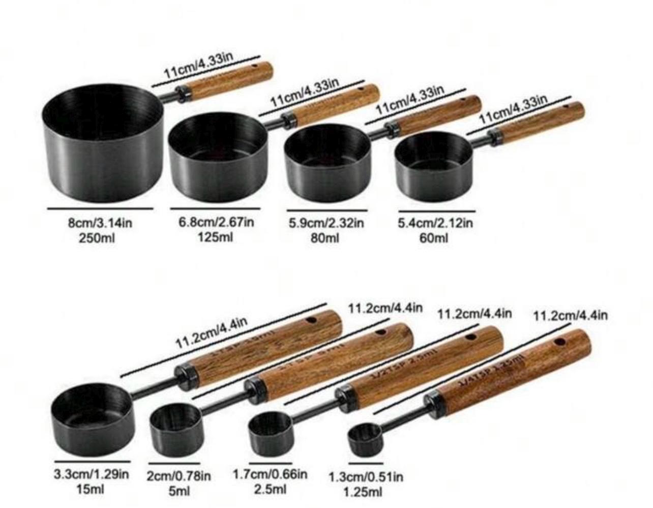 Set of measuring cups with wooden handles and measurements labeled.