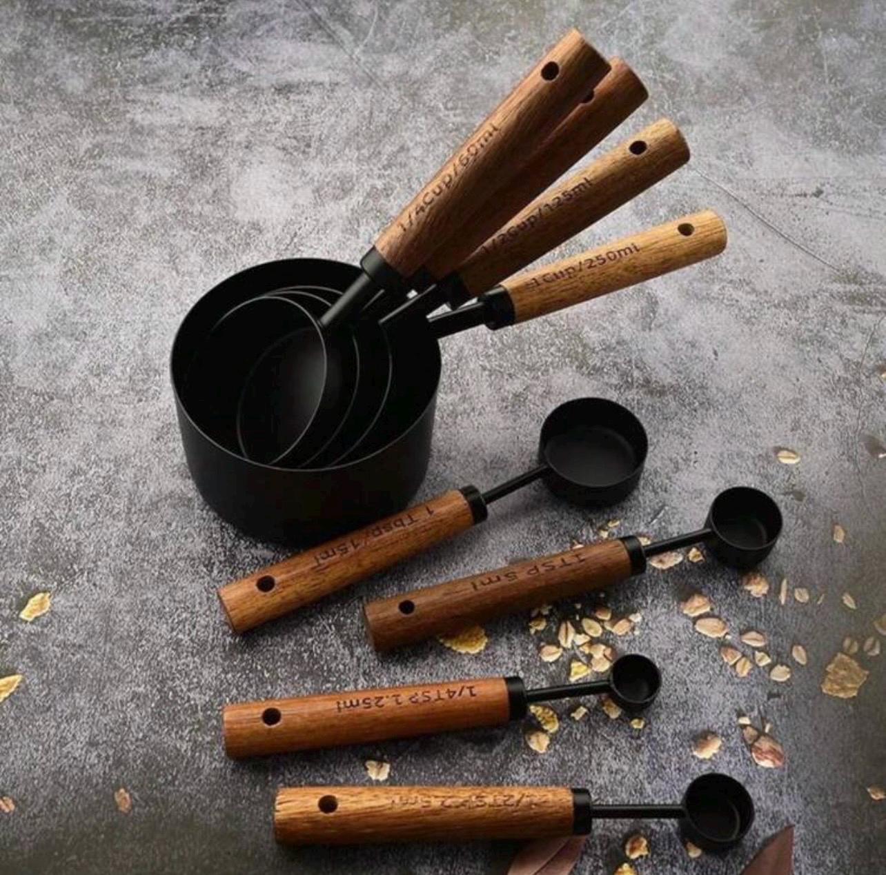 Set of measuring cups with wooden handles on a gray surface